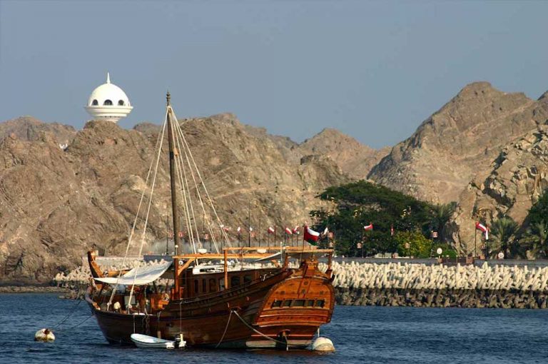 Traditional dhow at sunset off Muscat