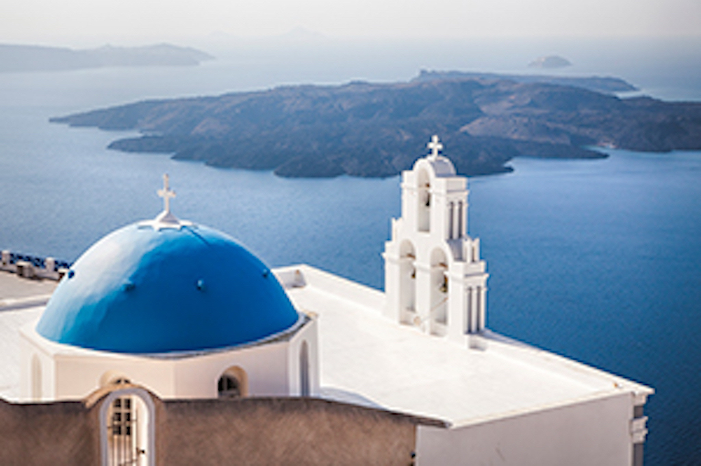 The white houses and blue domes of Santorini above the caldera, Greece